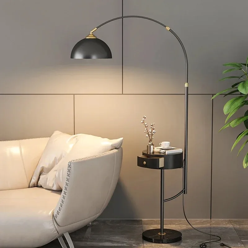 

New modern LED wireless charger gold black metal floor lamp with drawer next to living room floor lamp