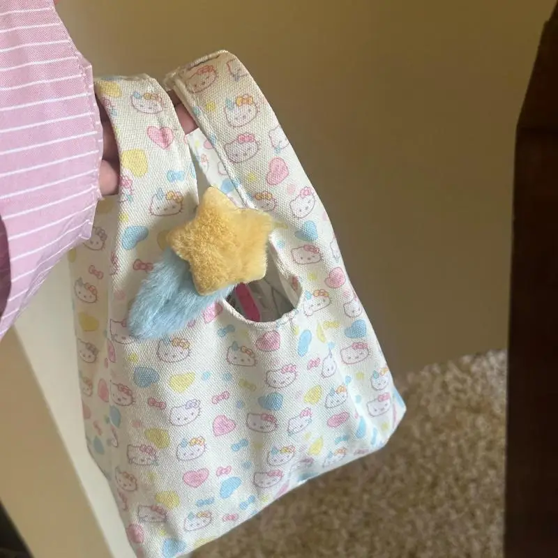 لطيف الكرتون Kawaii Sanrioed Hellokitty 2025 حقيبة المعصم الجديدة المحمولة مفتوحة الأعلى تنوعا باليد حقيبة نسائية للتنقل