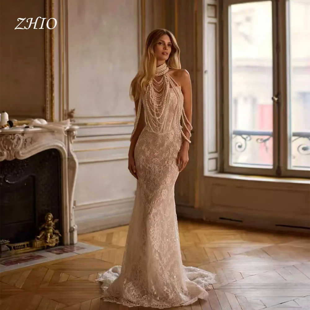 ชุดแต่งงานหรูหรา ZHIO ประดับมุก คอร์เซ็ทแบบผูกคอ ทรงเมอร์เมด ชายกระโปรงยาวลากพื้น สีไอวอรี่ ผ้าลูกไม้ ชุดราตรีเจ้าสาว สามารถสั่งตัดได้