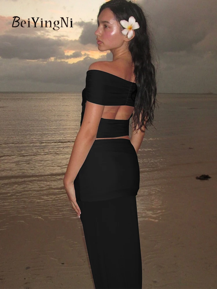 Beiyingni 2025 nueva moda mujer faldas conjuntos de 2 piezas Sexy flaco sin espalda Slash cuello camisetas chándales mujer negro azul conjunto