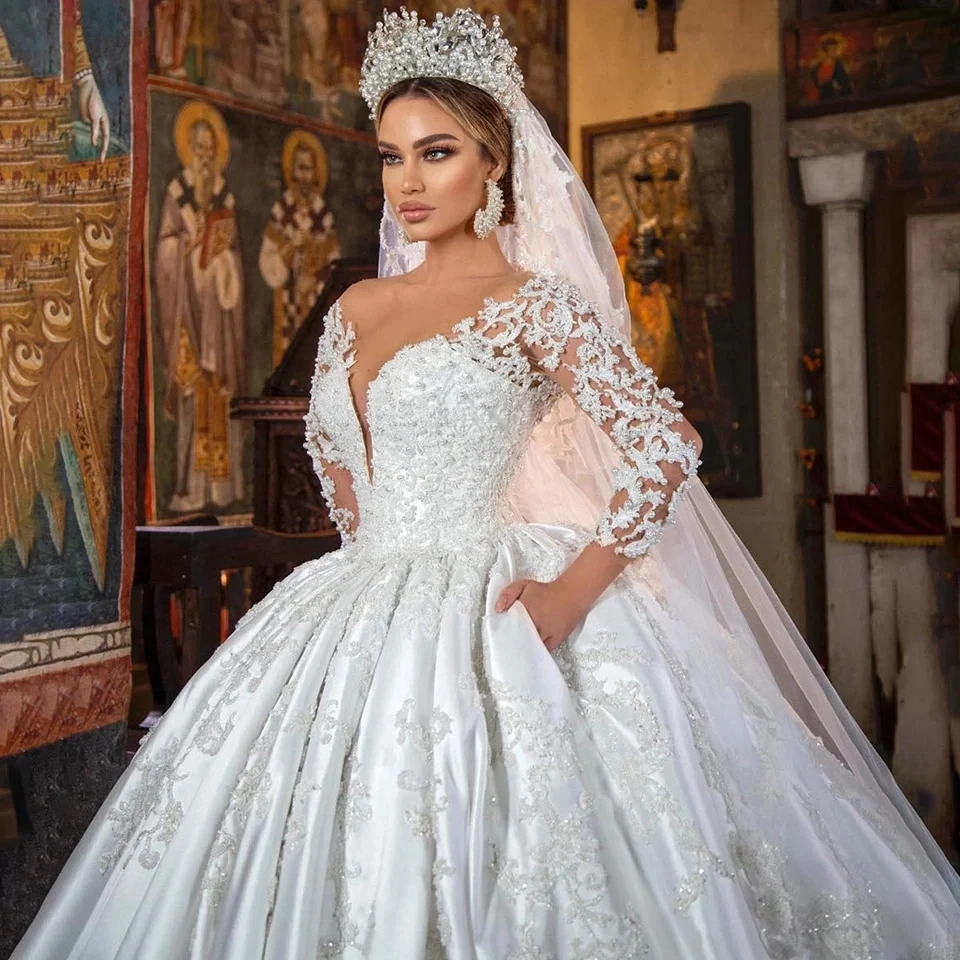 2025 Luxury Princess Satin Wedding Dress Lace Pearls Beaded Sheer Neck Long Sleeves Bridal Bride Gowns Arabic Vestidos De Noiva