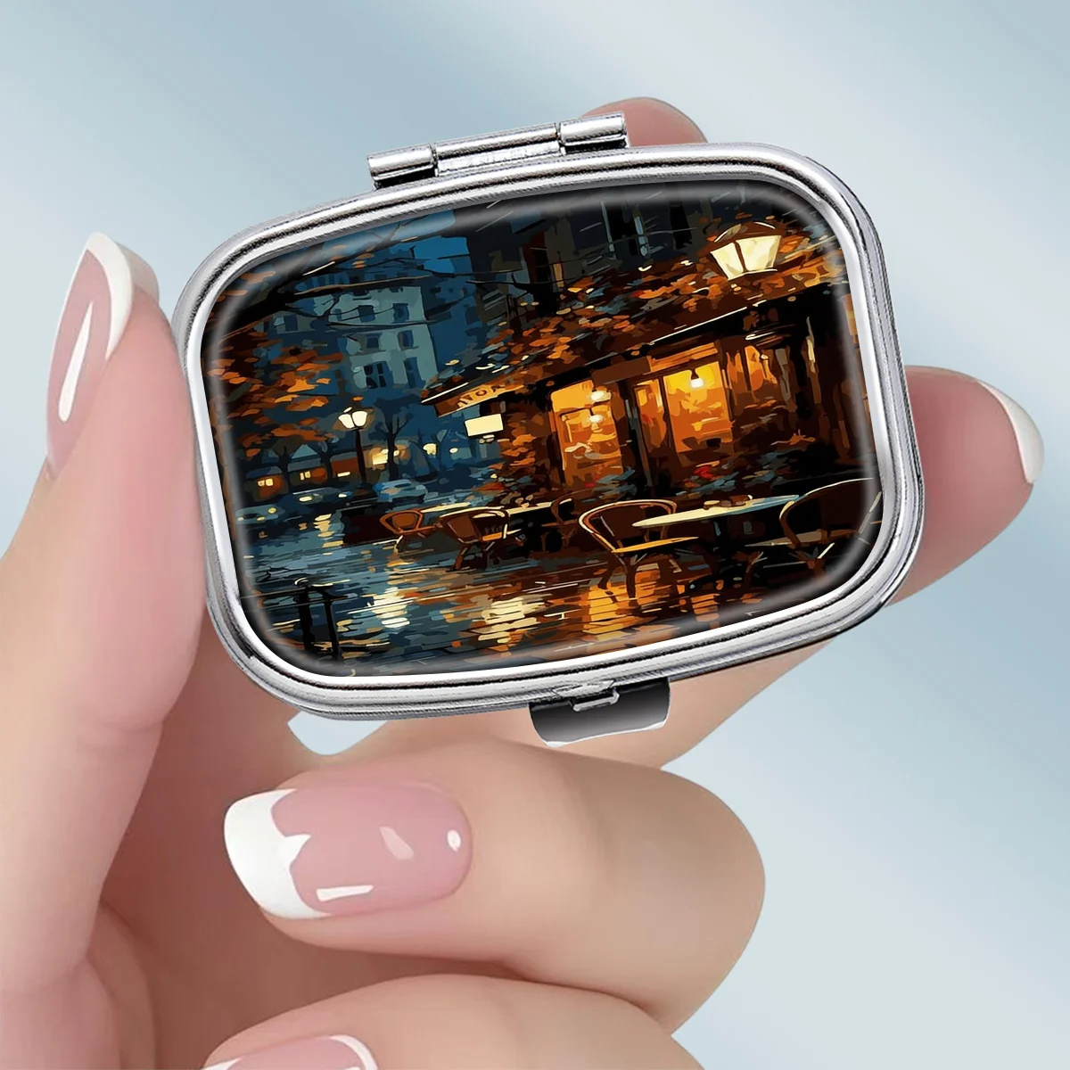 1PC portable square metal pill box, featuring a romantic and laid-back scene of a rainy night cafe, with a 2-compartment design, perfect for elegantly storing your medication or supplements. It is very suitable for sorting vitamins and storing small items