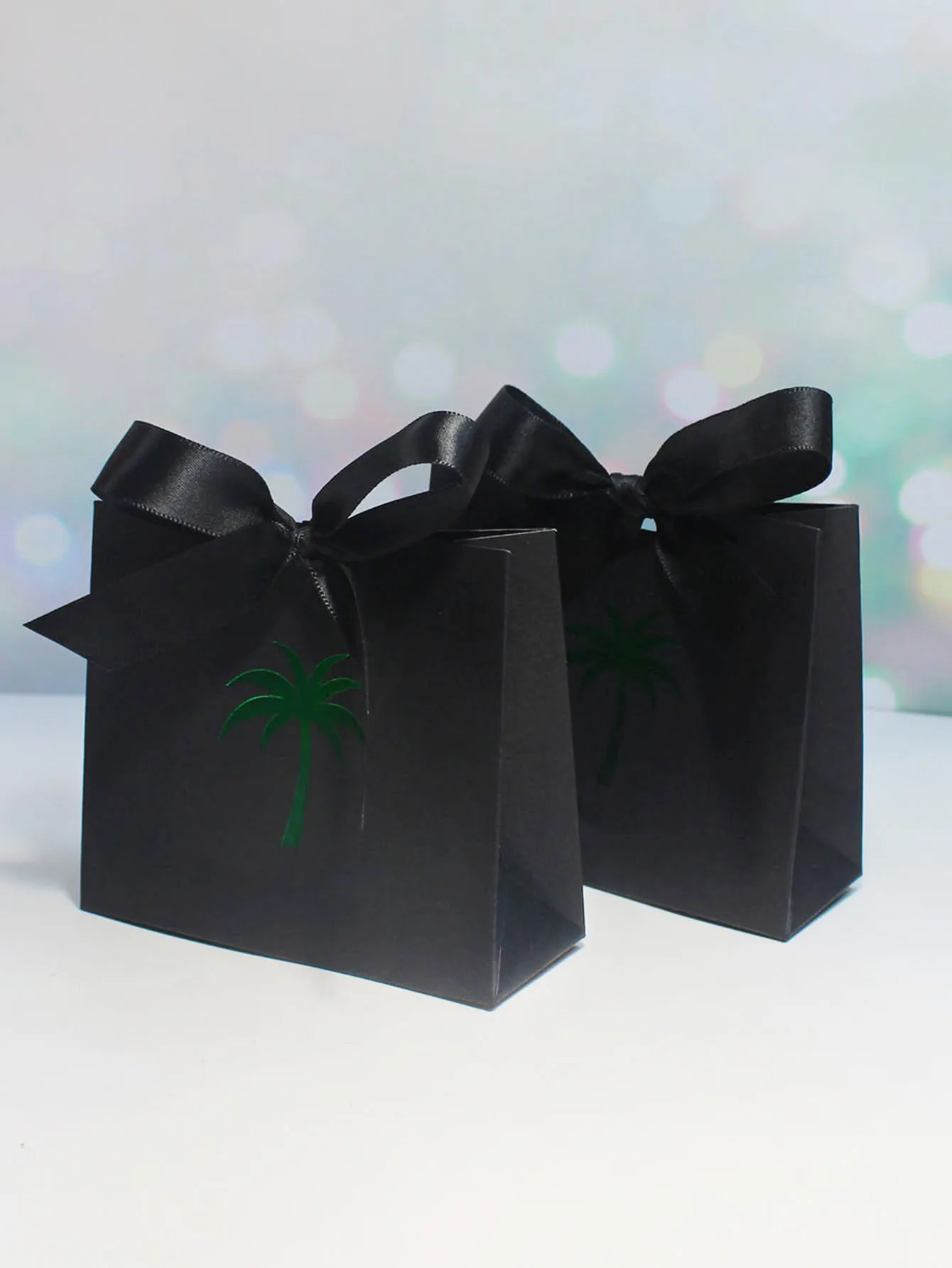 Sophisticated Black Gift Boxes with Green Palm Detail and Satin Ribbons - Perfect for Elegant Gifting and Special Occasions