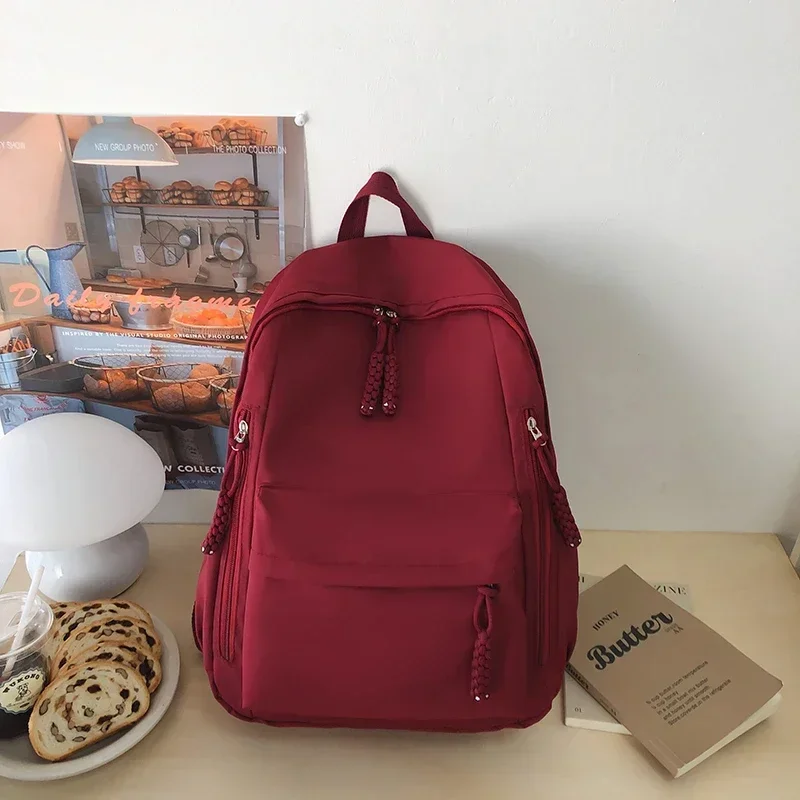 Bolsa de escola de nylon simples com zíper sólido de alta capacidade Mochilas de moda para meninos e meninas, linha de costura, 2024