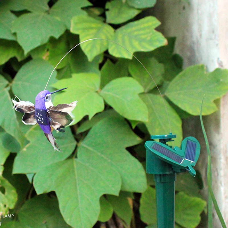 

Solar energy simulation of blooming flowers and butterflies rotating birds tourist handicrafts featuring flying butterflies.