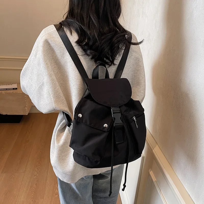 

2025 Korean Style Popular Solid Colour Nylon Women Fashion Backpack Flap Drawstring Backpack Gentle Versatile Students Schoolbag