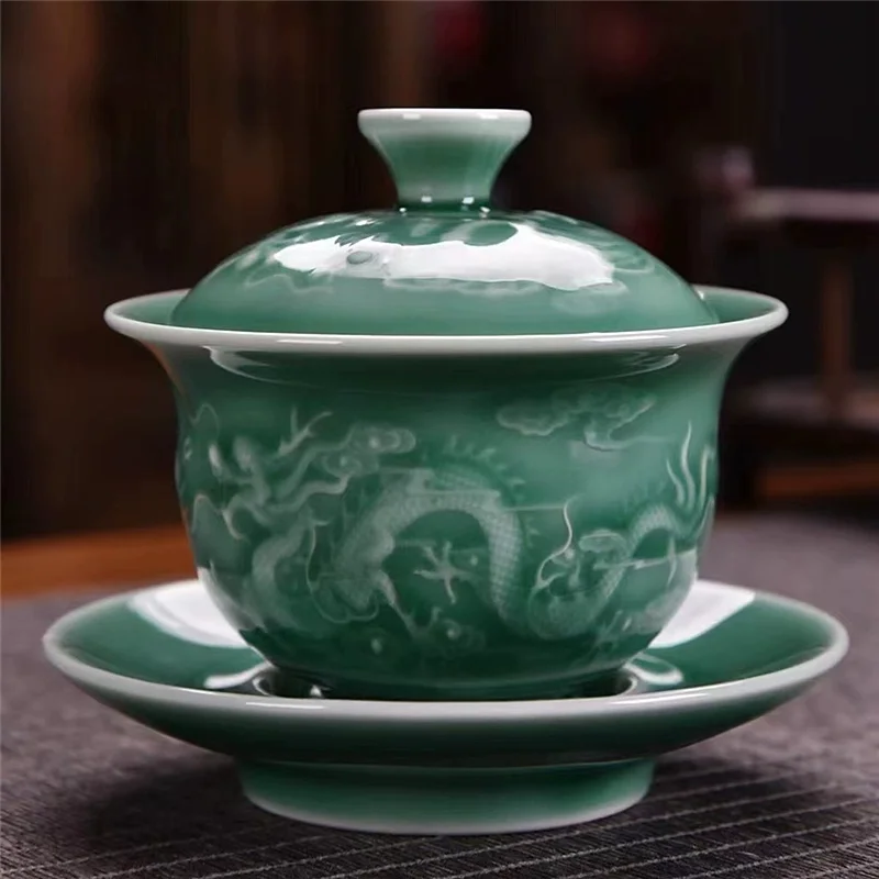 

Three piece set of Chinese green glazed dragon patterned master tea cups