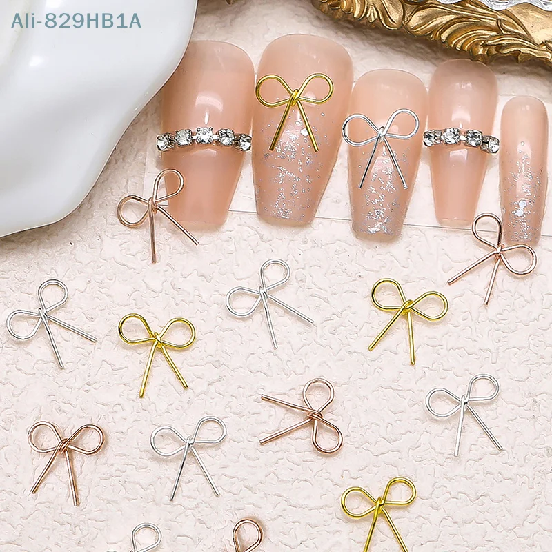 10 stücke 3d Legierung Bowknot Nail Art Charms heiliges Band Bogen Nagel Dekorationen Silber goldenen Nagel Strass DIY Salon Luxus schmuck