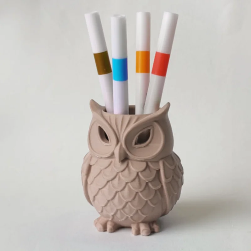 An owl statue, which can be used as a pen holder for the desk or as a decoration for the home