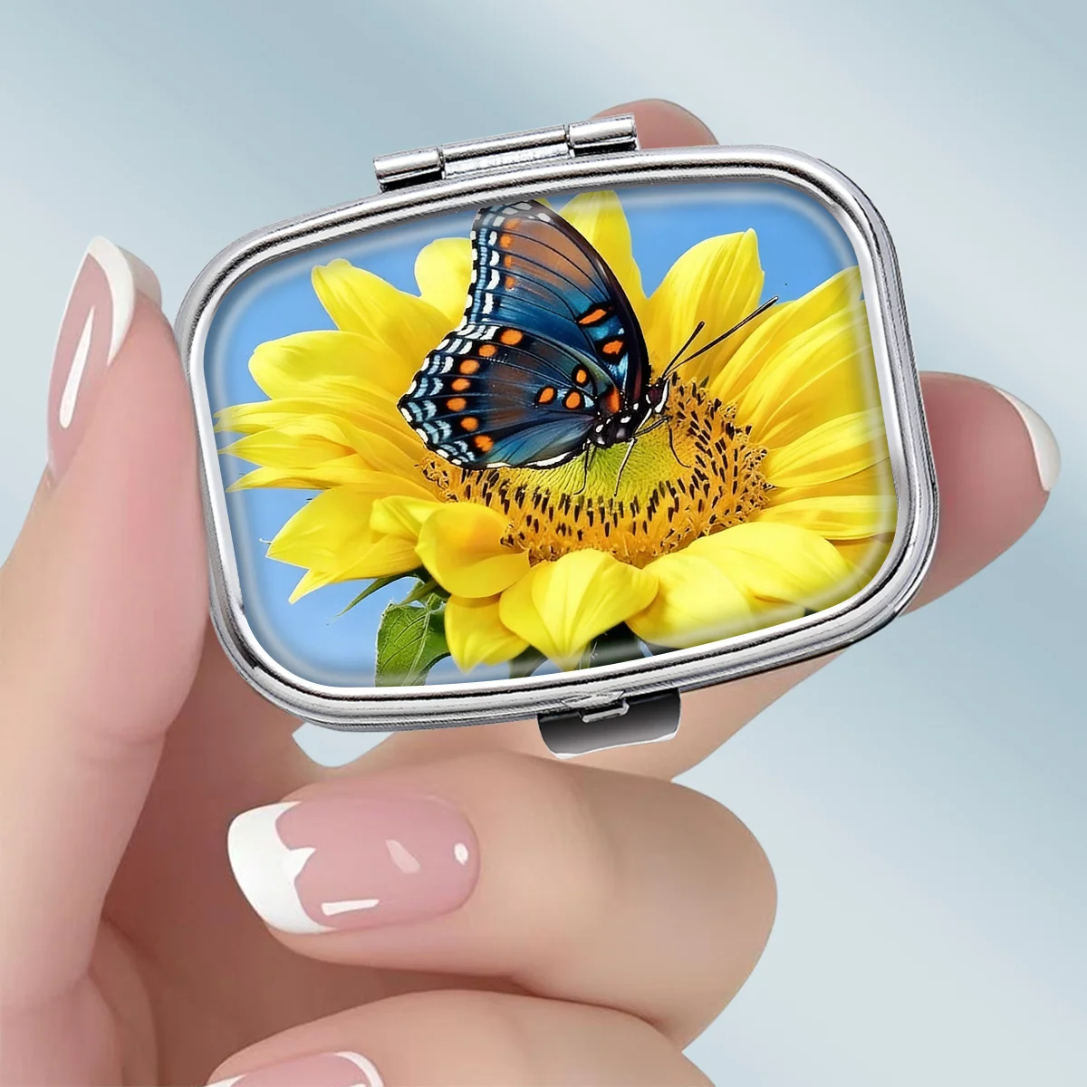 1PC compact 2-compartment square metal pill box, featuring a natural realistic sunflower and butterfly design, portable decorative vitamin storage box, or a unique gift for a wallet