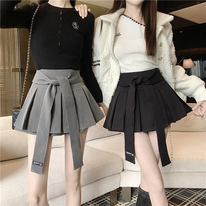 

Милая осенне-зимняя утягивающая плиссированная короткая юбка трапециевидной формы с высокой талией и поясом для женщин, прогулочная юбка имеет внутренние шорты