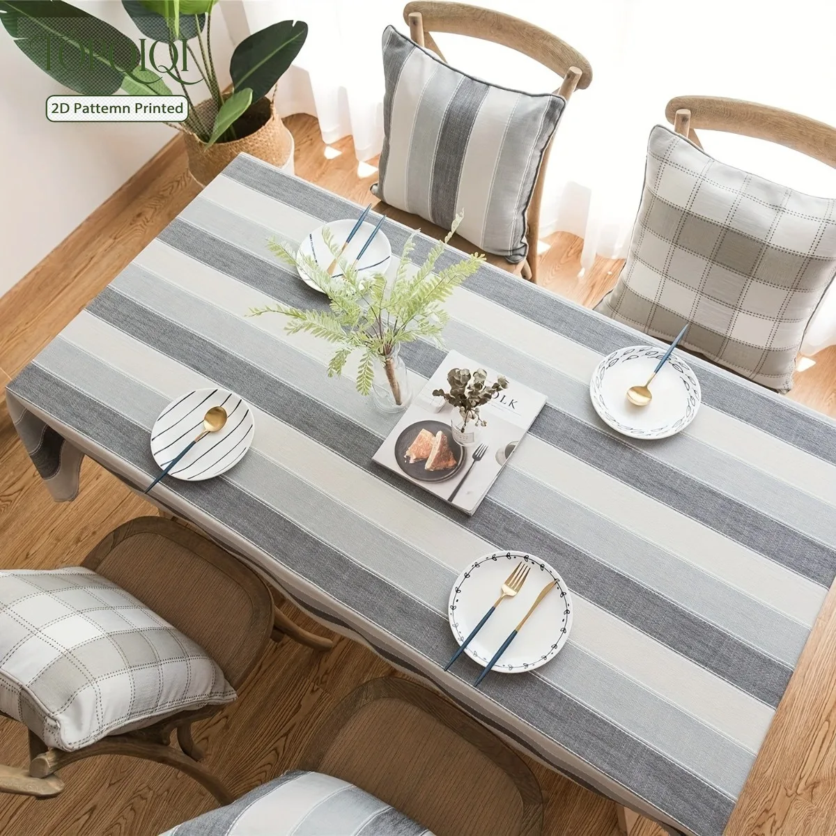 A striped three-color tablecloth for kitchen dining table decoration. Gray color.