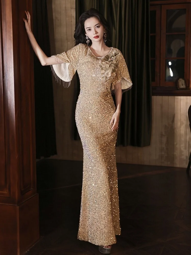 

A grand golden sequined fishtail dress for the banquet