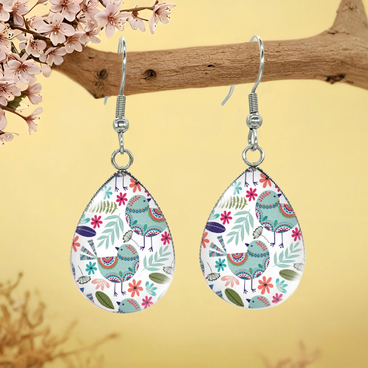 Hand drawn flowers and birds illustrate fashionable drop earrings glass jewelry gift