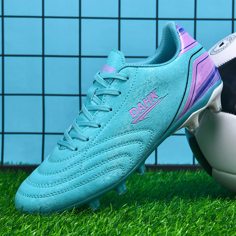A pair of children's slip-on football shoes with long spikes and durable design suitable for all seasons, product number: HX-X32