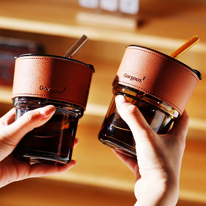 Glass drinking tumbler with lid and straw