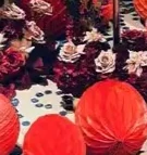 

The female party's morning gown is photographed with a long strip of happy words and a lantern with floral patterns