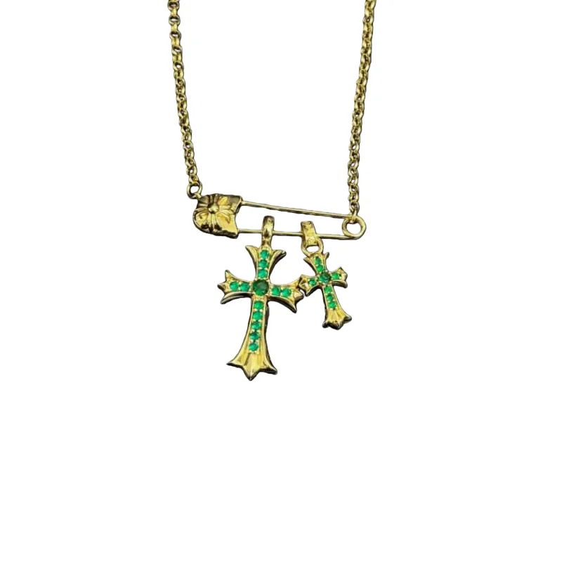 

Gold-Tone Safety Pin Double Cross Pendant Necklace with Emerald Rhinestones – Gothic Luxe Statement Jewelry