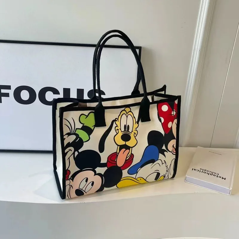 2025 New Disney Cartoon Animation Handheld Travel Shoulder Tote Bag Commuting Canvas Bag Female Mommy Bag Large Capacity Bag