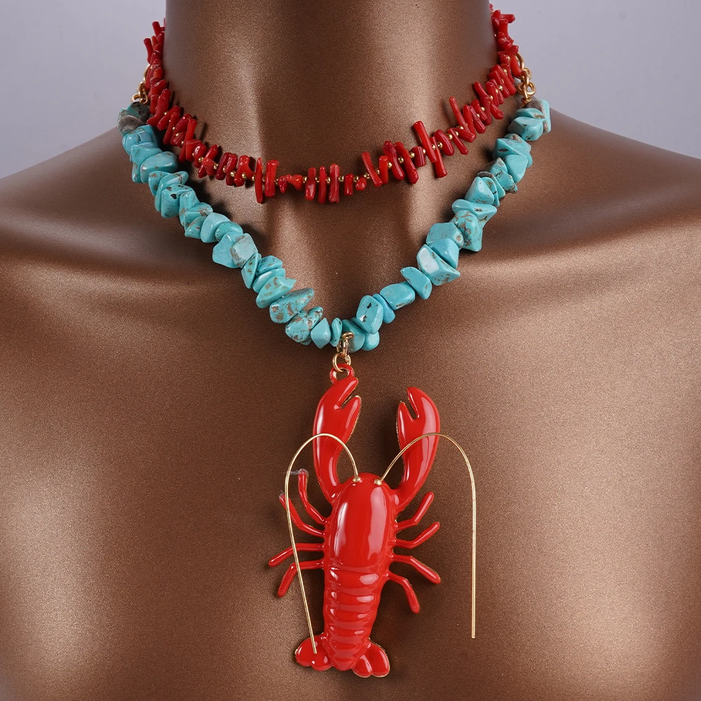 A Woman Wearing A Cute Red Lobster Pendant Necklace With A Coral Necklace Featuring Blue Irregular Natural Stone