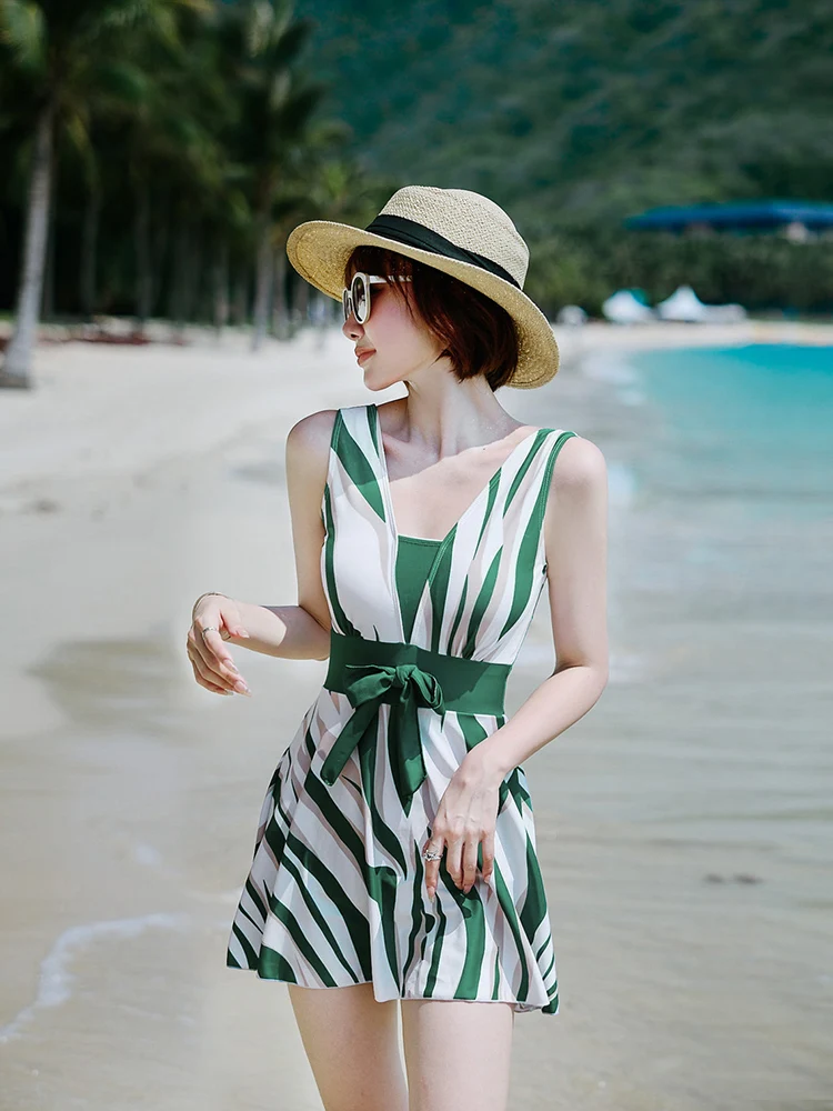 Women's one-piece dress-style swimsuit, featuring a conservative design that conceals the figure and offers a slimming effect