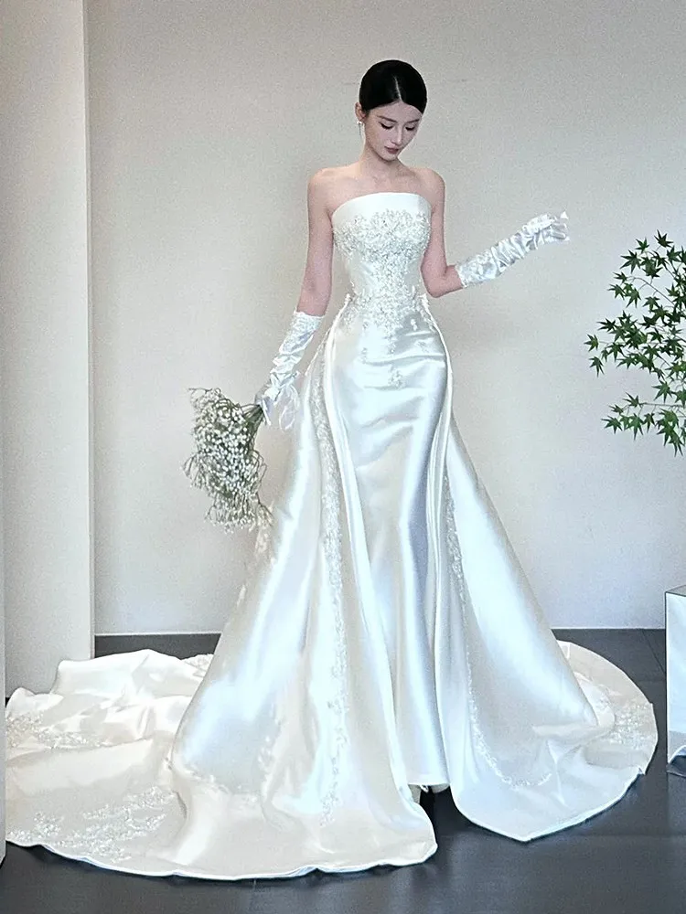 

A new high-end custom-made dress with strapless satin fishtail and large drag tail