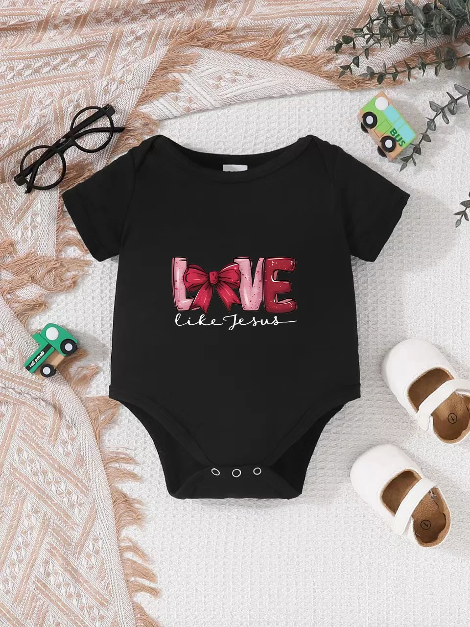 Playful letter-printed baby short-sleeve triangle bodysuit. Button closure for easy dressing