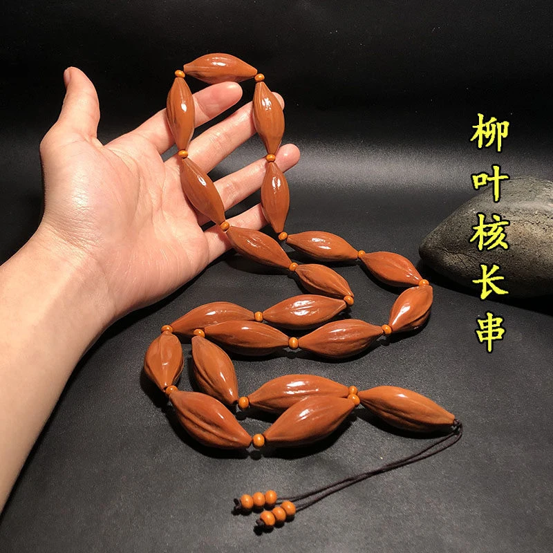 carving, slender leaf-shaped , 1.7mm old oil , long string hanging as a necklace, olive core pendan