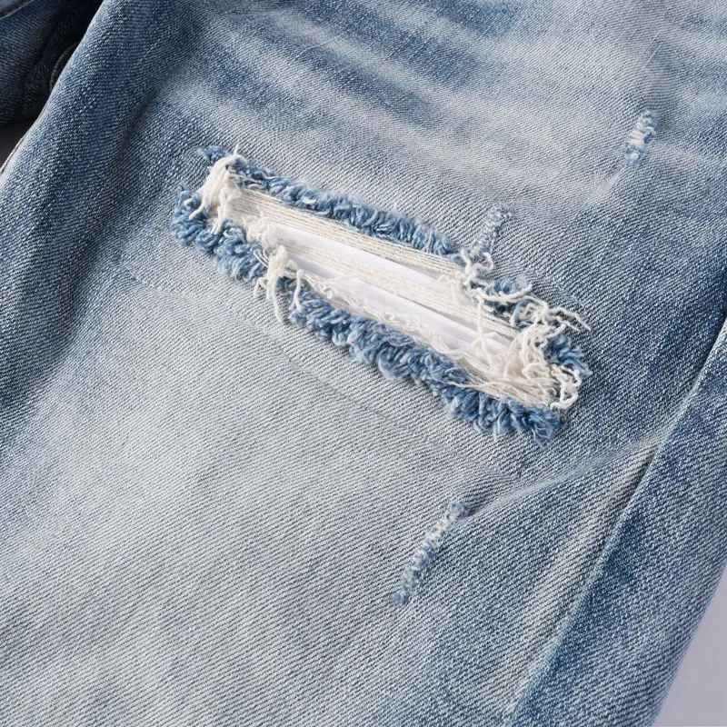 

designer's fashionable newY2K denim jeans, washed with nostalgia, stretchy, slim fit, light blue, ripped patch, men's j