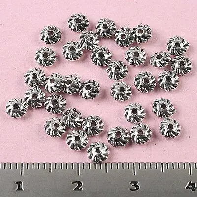 

200pcs 4x1.6mm Tibetan Silver Gyrate Beads H0502