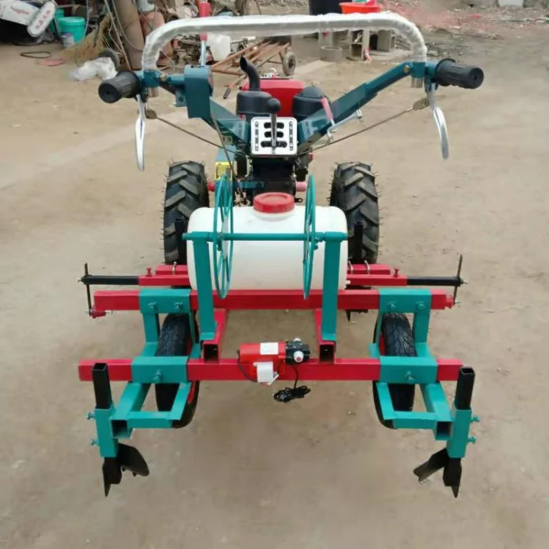 

Hand-operated tractor film applicator with spraying function for crop soil temperature protection.Video of spraying and film ap