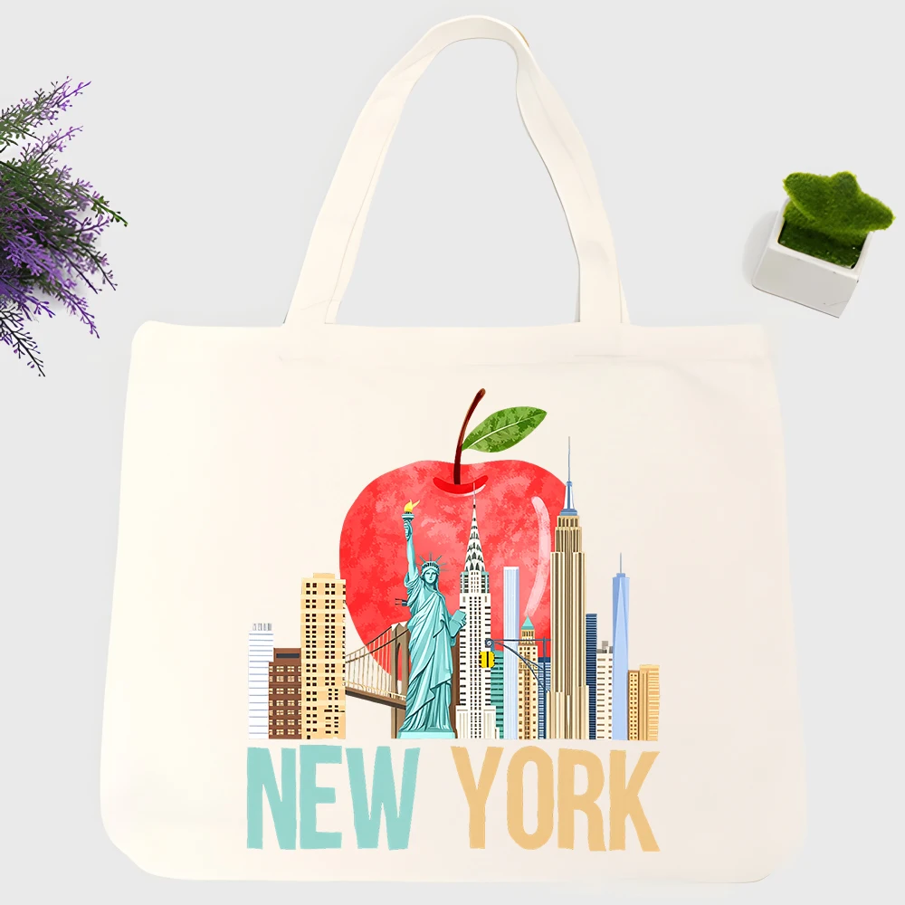 Women's New York skyline with apple graphic canvas tote bag, urban style for daily shopping and casual outings