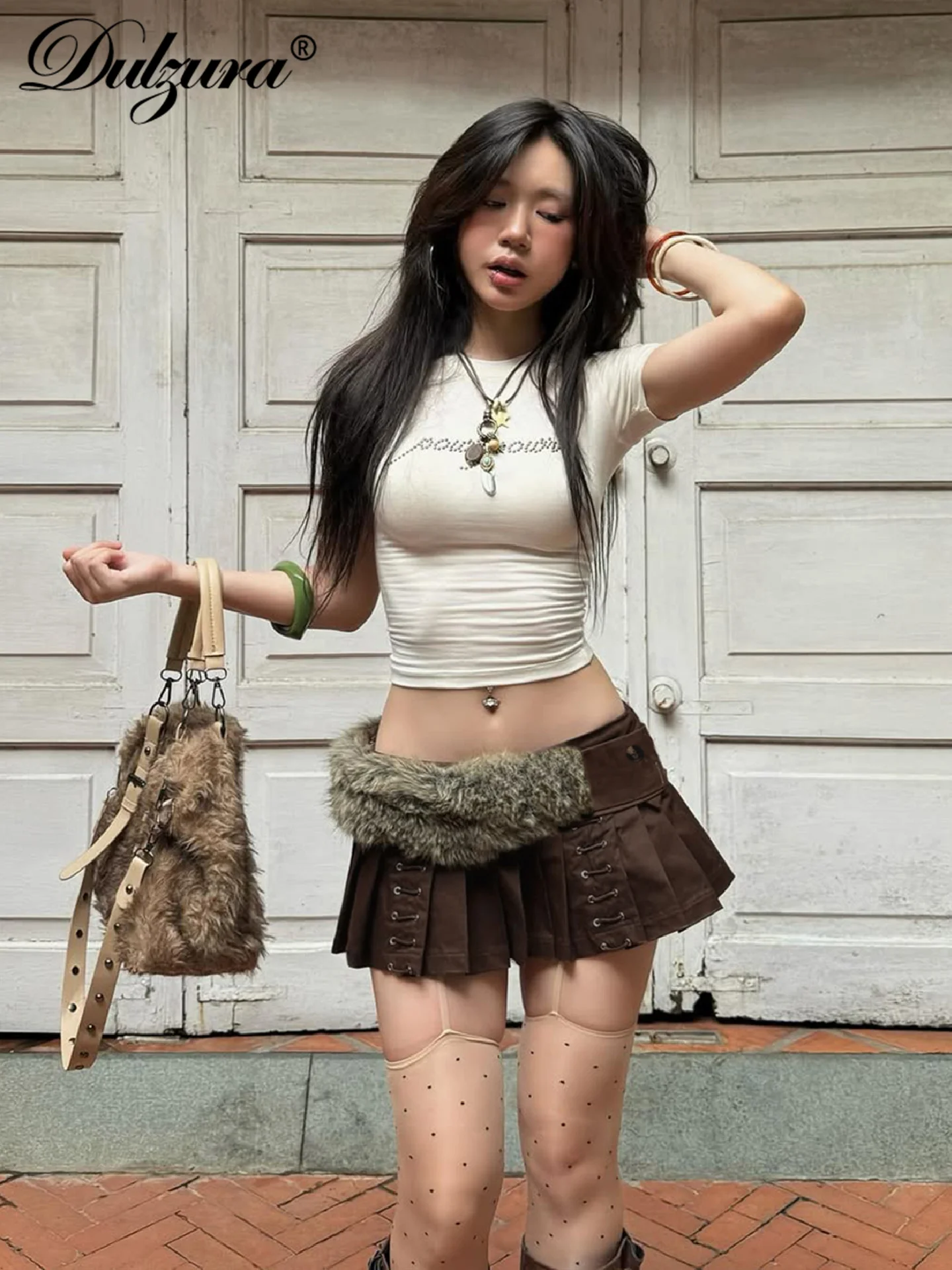 Dulzura femmes mode Sexy décontracté Mini jupe trous fermeture éclair mince plissée jupe courte fête Club rue vêtements d'été en gros