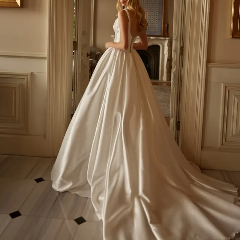 Satynowe suknie ślubne w kolorze kości słoniowej z aplikacjami, z odkrytymi ramionami, spódnica typu A, aplikacje kwiatowe, suknie ślubne szyte na miarę.