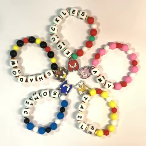 Sonic beaded bracelets: colorful, with "SONIC"/"TAILS" letters. Fun fan accessories.