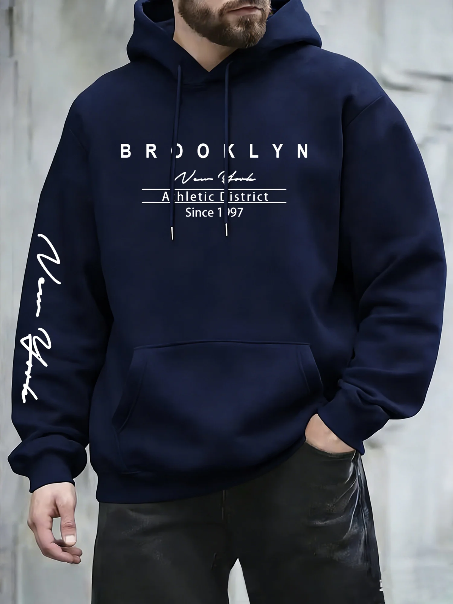 Urban fashion men's hoodie on the streets of New York. Simple text signature print. Loose and comfortable long-sleeved hoodie.