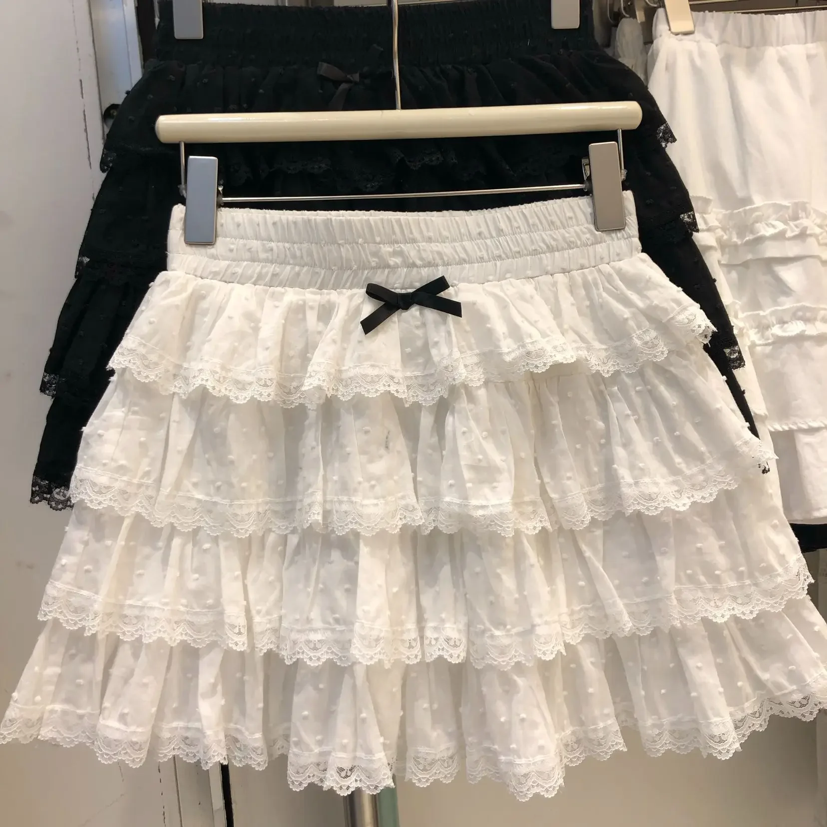 جديد فراشة عقدة الأبيض تنورة قصيرة عالية الخصر ألف خط كعكة تنورة المرأة النقي التطريز المضادة للضوء الطبقات نصف تنورة