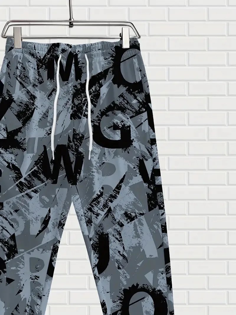 I nuovi pantaloni da uomo per la primavera e l'autunno del 2025 sono comodi, morbidi, casual e con stampe di lettere per pattinaggio a rotelle