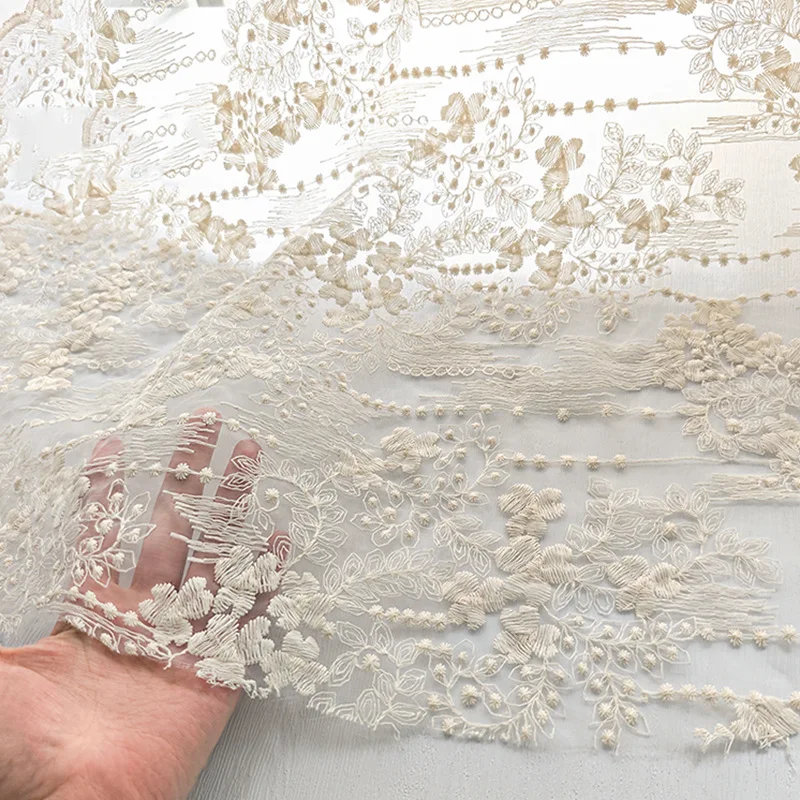 

High quality Organza lace fabric with embroidered small floral patterns in apricot color, used for bridal gown designers