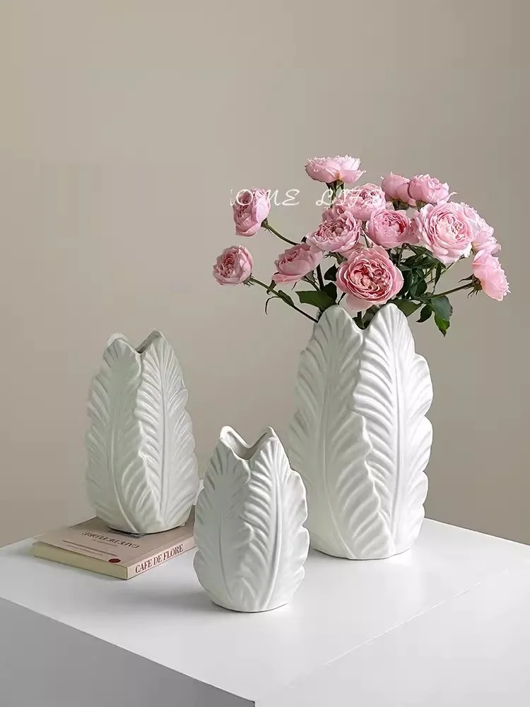 White minimalist ceramic vase with a creamy style and a high-end feel. Aquatic flower arrangement, living room, dining table dec