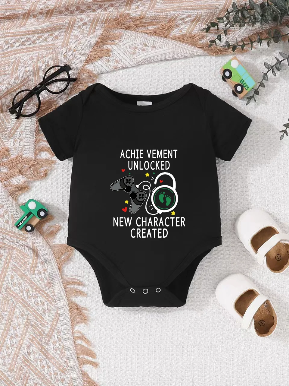 Playful letter-printed baby short-sleeve triangle bodysuit. Button closure for easy dressing