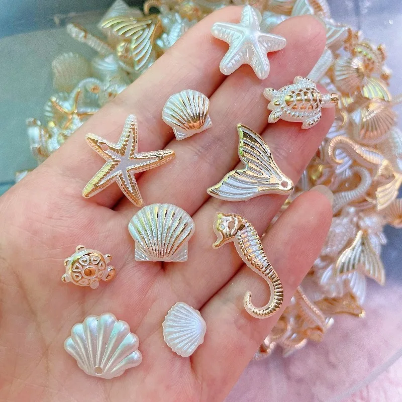 A set of 35 acrylic beads containing a variety of marine life such as starfish, seahorses, snails, and fish, perfect for making your own jewelry