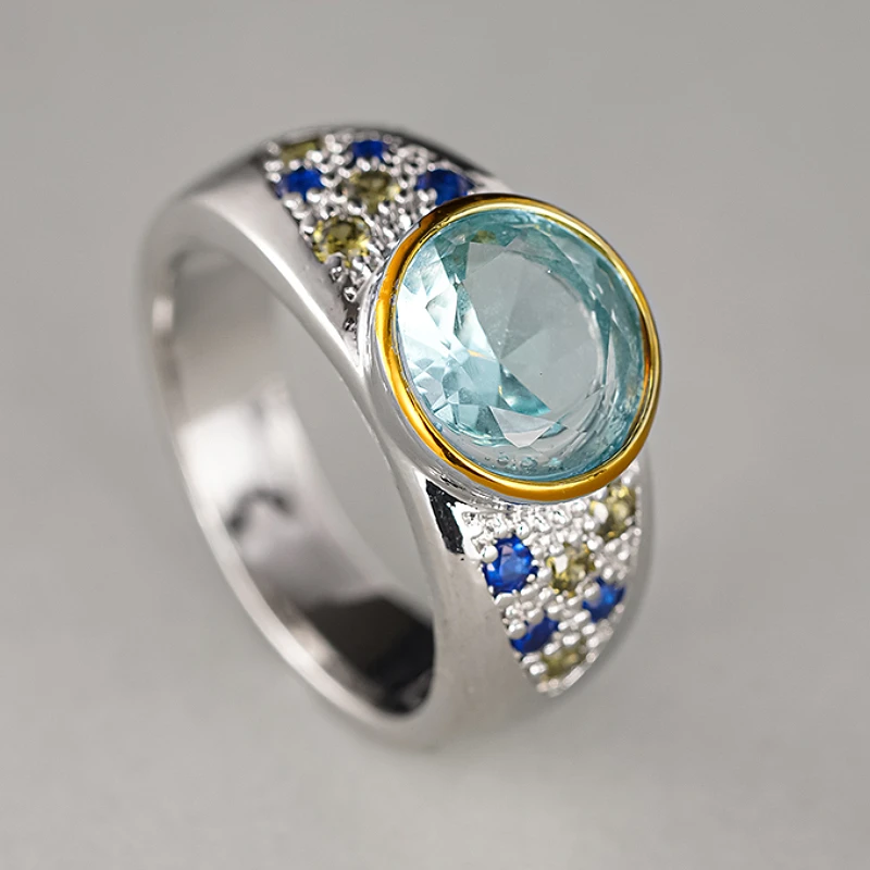 Huitan Damen-Ring in zwei Farben, eingelegt mit hellem, rundem, blauem Zirkonia, modisch, für Party, Hochzeit, edle Accessoires, Modeschmuck, Geschenk
