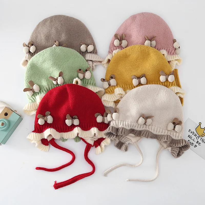 

Милая детская шапка с бантом и рюшами, зимняя утолщенная вязаная теплая шапка со шнуровкой для младенцев, однотонная шапочка для защиты ушей для новорожденных девочек, шапочка