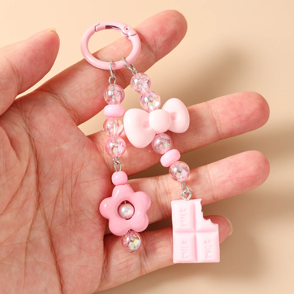 Modische handgefertigte Perlen-Schlüsselanhänger mit Schleife, Harzblumen- und Schokoladenanhänger für Damen, Herren, Autoschlüssel und Handtaschen – Detail 2
