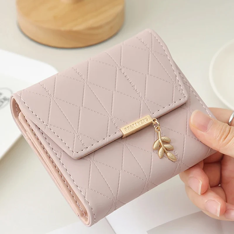 Autumn and winter new women's short wallet Japan and South Korea small fresh PU simple folding hardware leaf pendant three fold