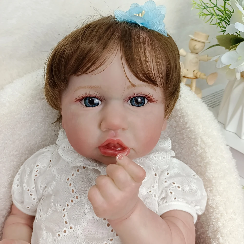 

22 Inch Vinyl Reborn Baby Doll, Blue Eyes, Flower Headband, White Outfit, Posable Limbs, Realistic Facial Features & Expression,