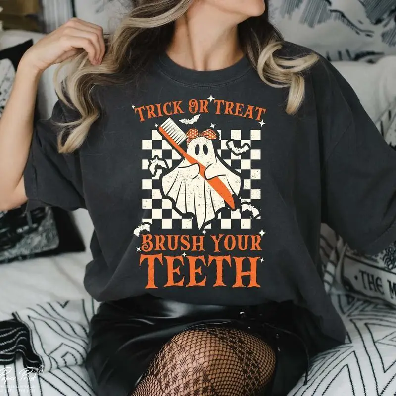 

Funny Halloween T-Shirt, Trick or Treat Brush Your Teeth Ghost Graphic Tee, Unisex Spooky Dental Humor Gift Top