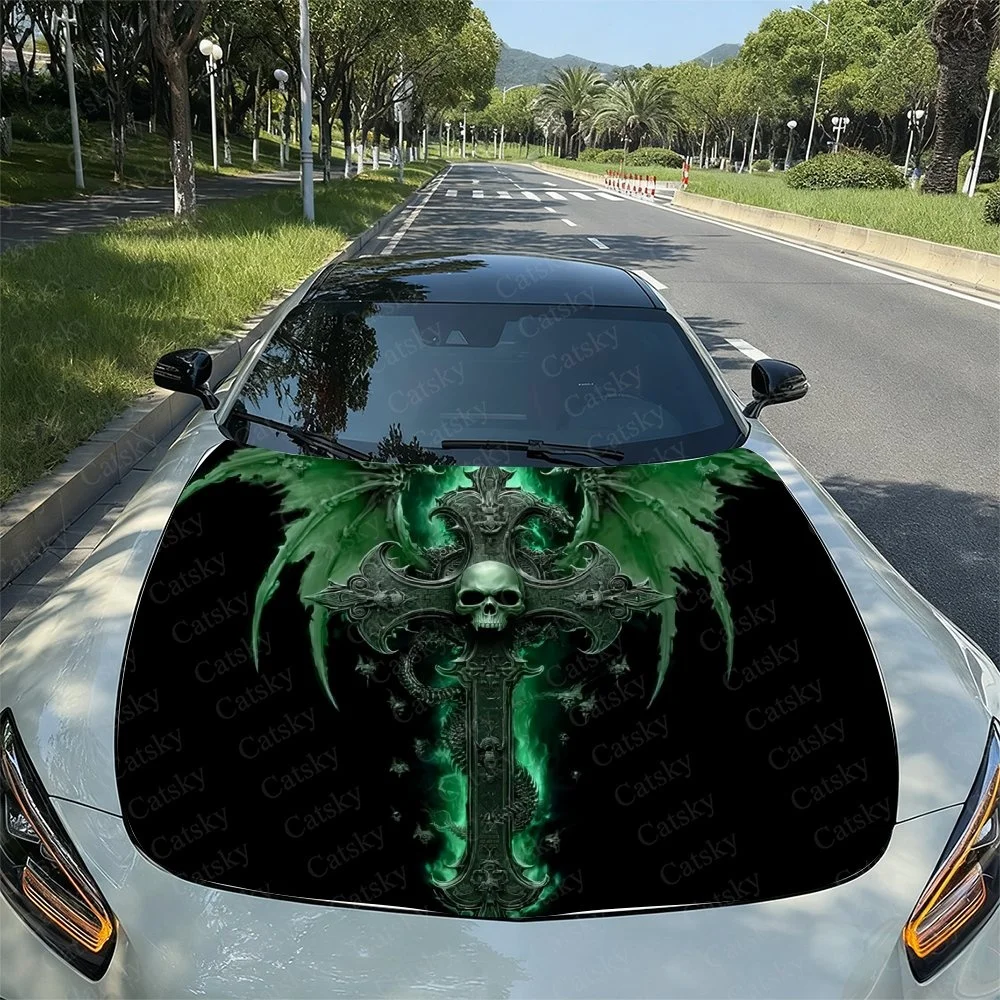 Gothic skull design with green wings and cross on a car hood. Perfect for unique vehicle styling. Fits various models seamlessly