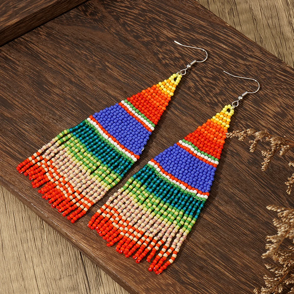 A pair of colorful striped Bohemian vacation style Su Mi bead woven earrings, hand woven earrings accessories